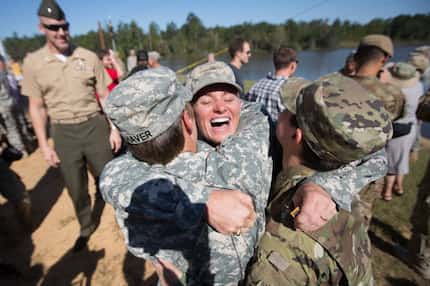 Maj. Lisa Jaster (center) embraced First Lt. Shaye Haver (left) and Capt. Kristen Griest...