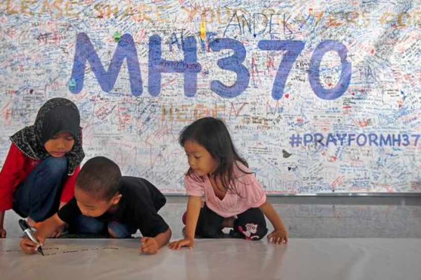 
Children wrote messages on a banner filled with well wishes for those aboard the missing...