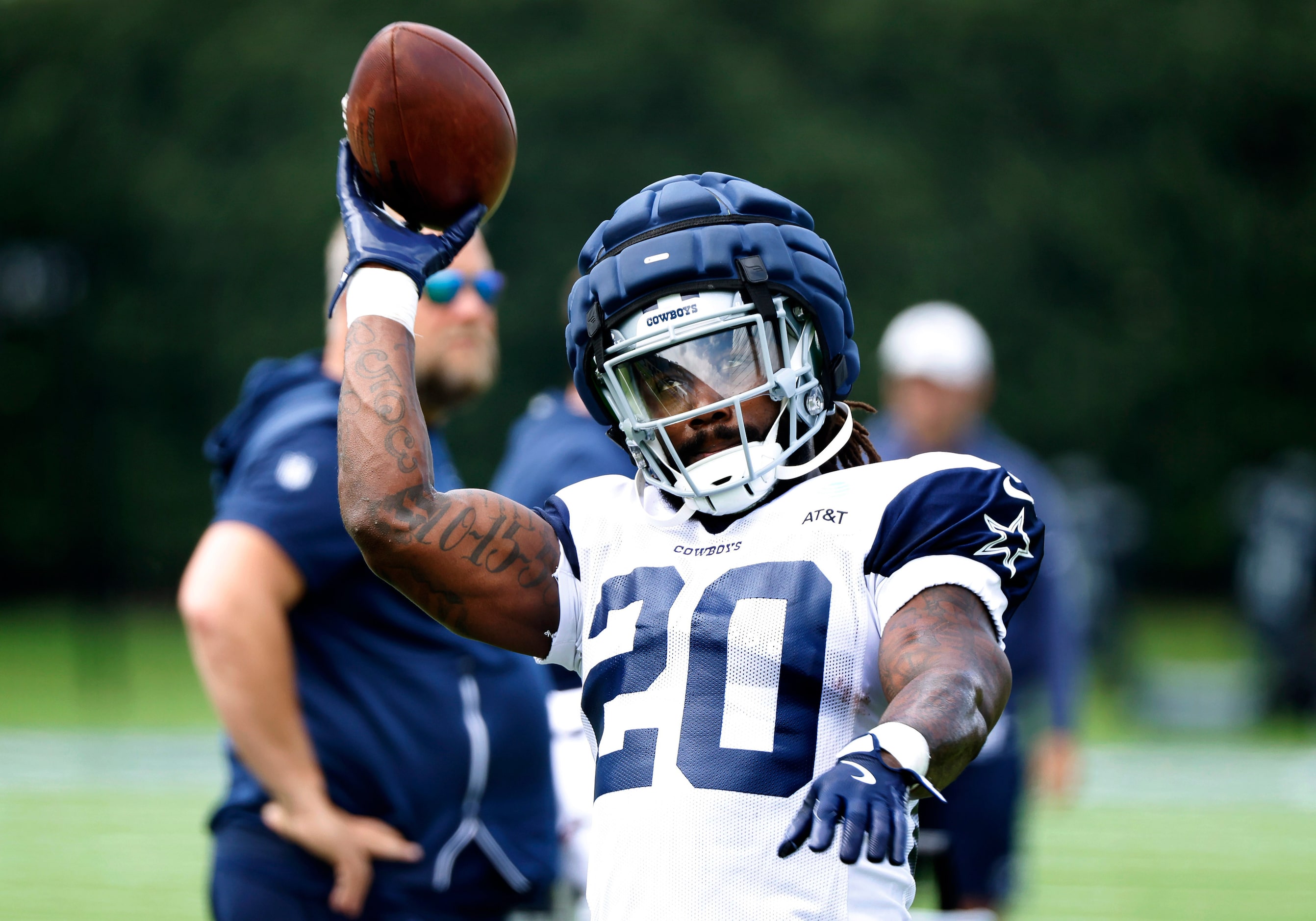 Dallas Cowboys running back Dalvin Cook (20) tosses the ball back as he ran drills during...