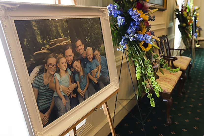 A family portrait of the Stephen and Katie Stay family sits on display for visitation...