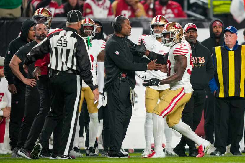 San Francisco 49ers linebacker Dre Greenlaw, right, reacts after being ejected from the game...