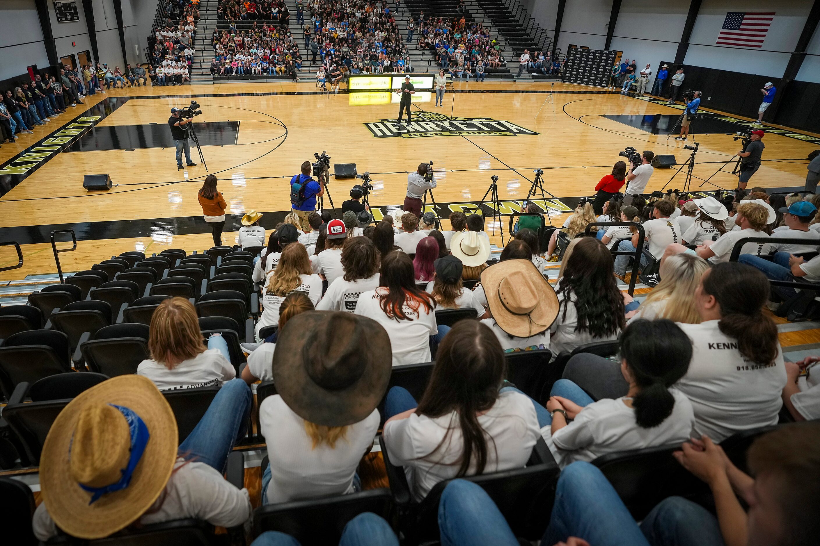 Troy Aikman addresses students during a pep rally at Henryetta High School.