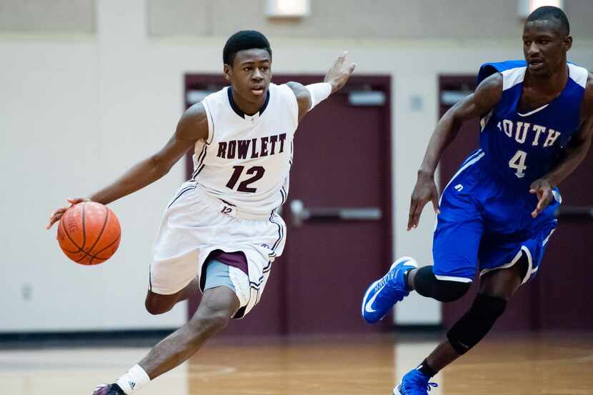 In this file photo from 2013, Rowlett Eagles guard Michael Kolawole (12) brings the ball up...