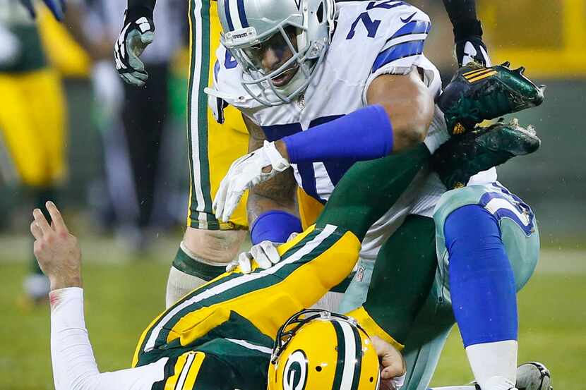 Dallas Cowboys defensive end Greg Hardy (76) stares down at Green Bay Packers quarterback...
