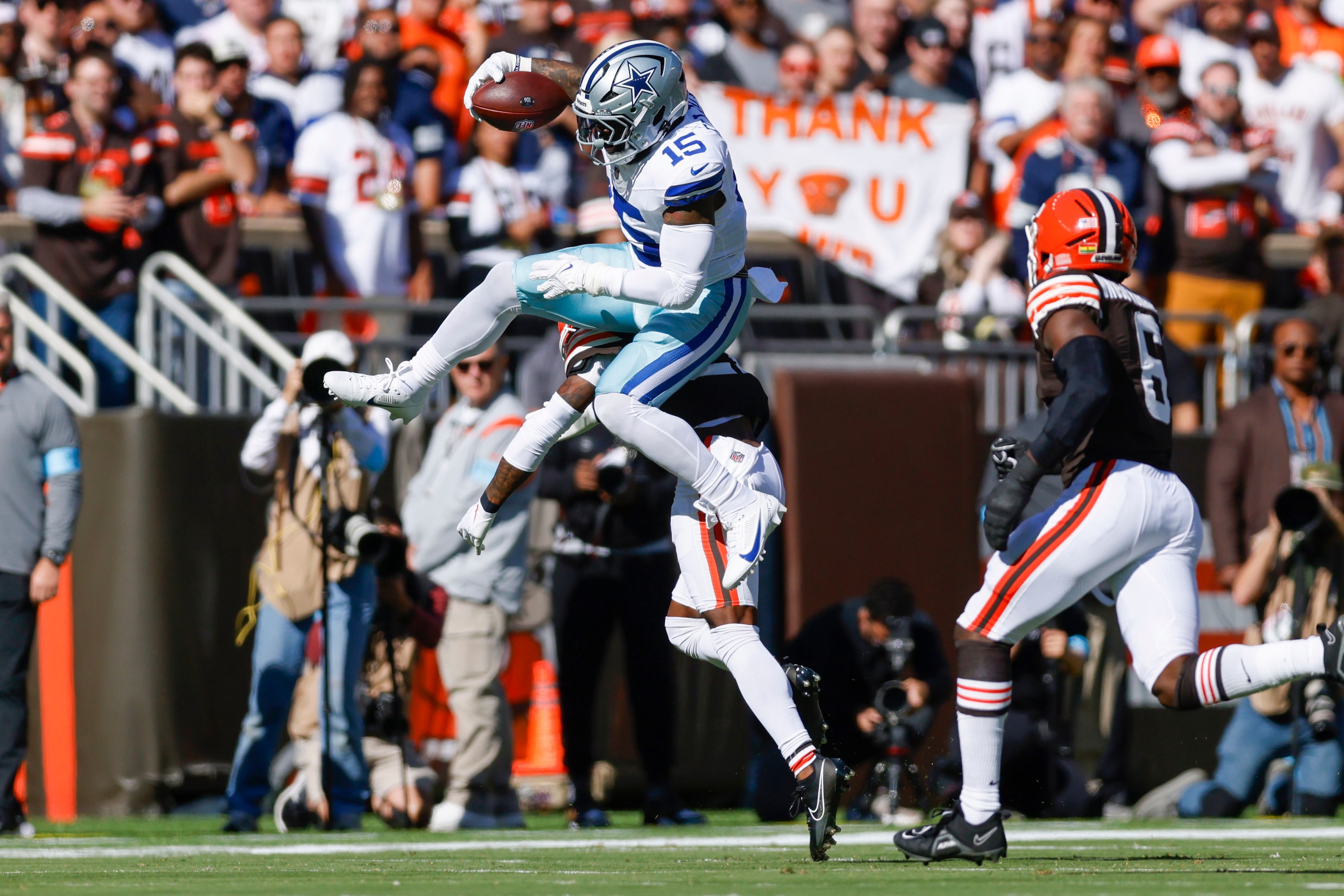 Dallas Cowboys running back Ezekiel Elliott (15) hurdles Cleveland Browns cornerback Denzel...