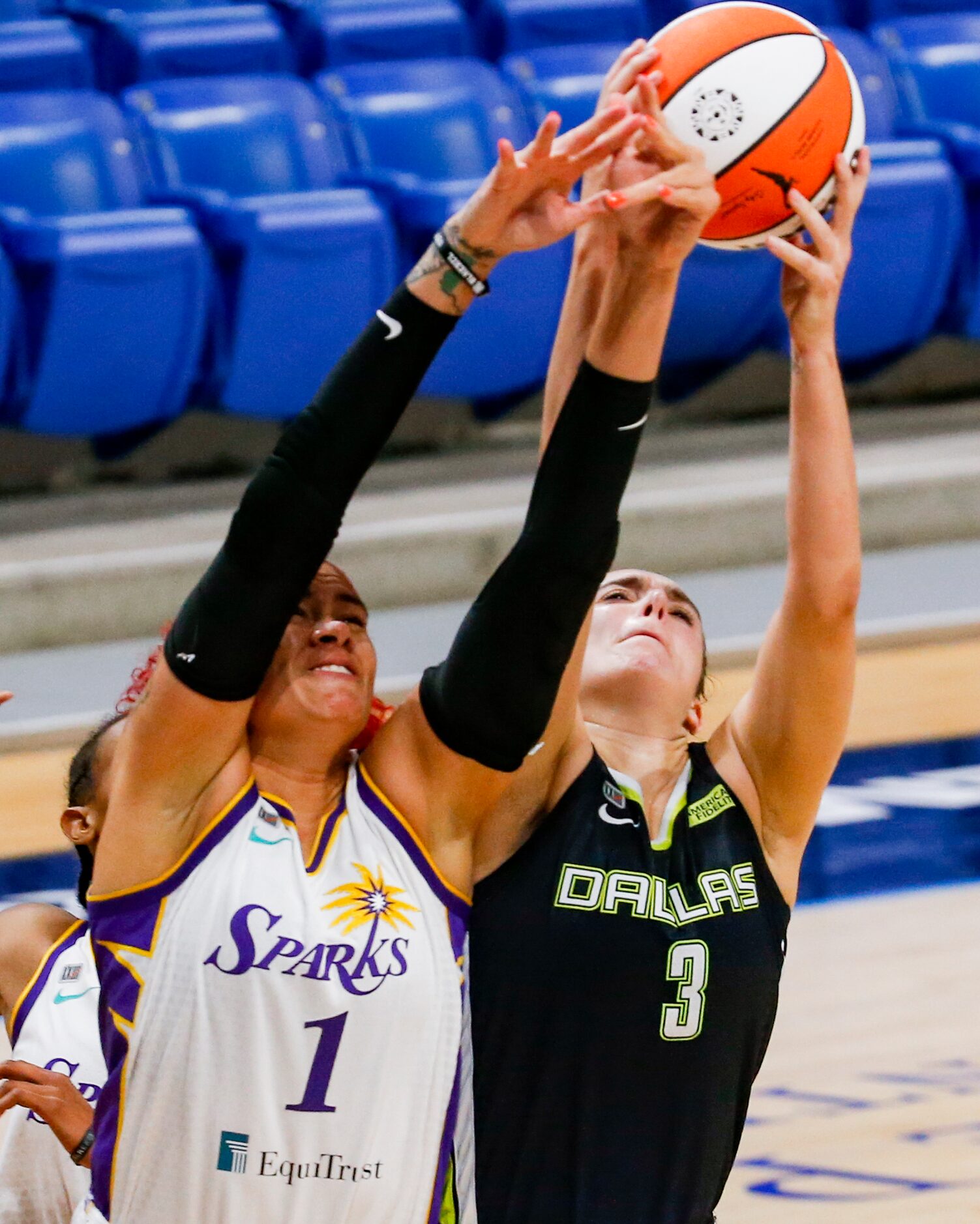 Dallas Wings guard Marina Mabrey (3) fights Los Angeles Sparks center Amanda Zahui B (1) for...