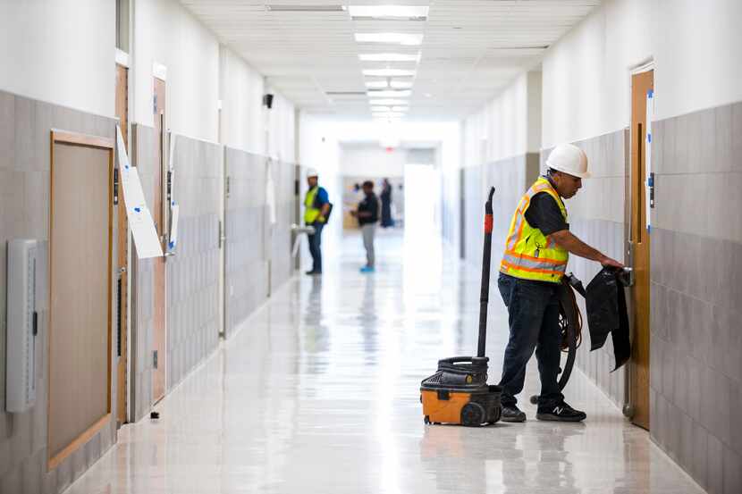 A worker moves cleaning equipment in a hallway on Thursday, December 19, 2019 at South Oak...