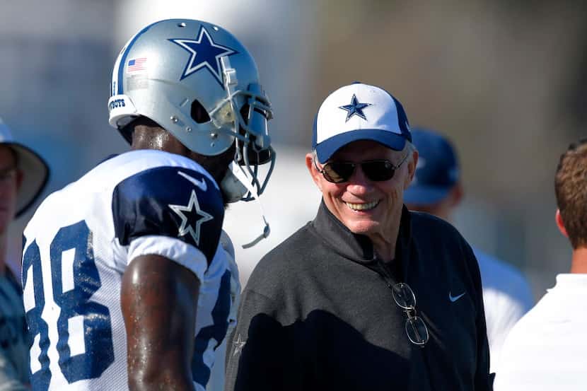 Dallas Cowboys owner Jerry Jones, right, talks with wide receiver Dez Bryant during a joint...