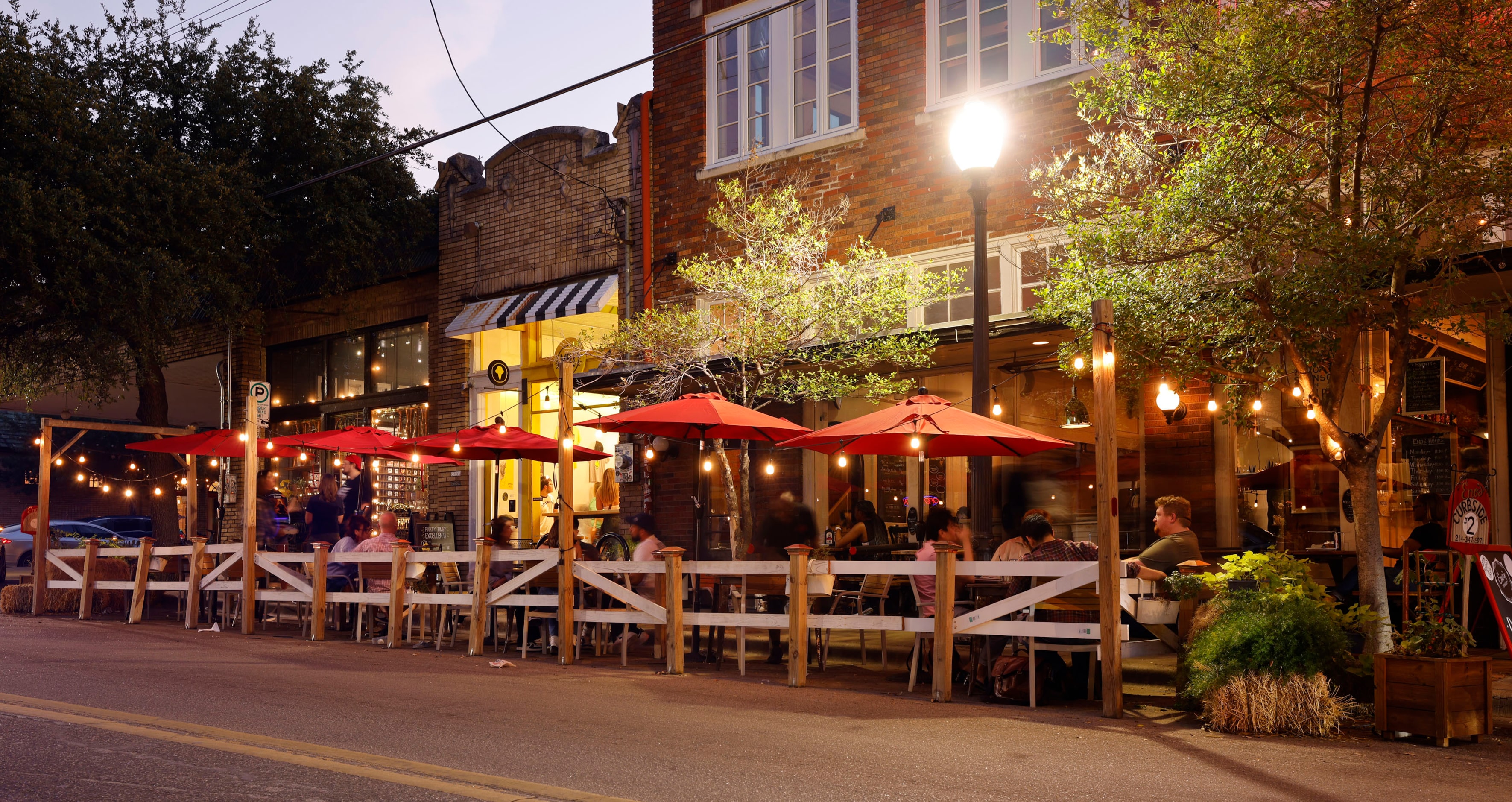 People sit on the patio at Eno's Pizza in the Bishop Arts District in Dallas, Saturday,...