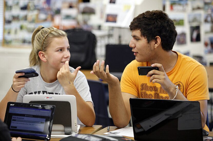 Emma McCrady, 15, of Lewisville, confers with classmate Daniel Rosas, 15, of Carrollton,...