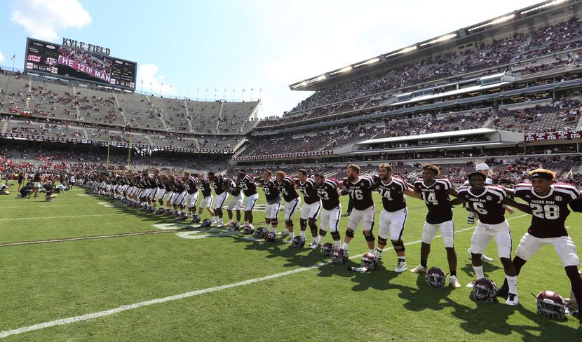 The Aggies are pictured at the end of the game after the Louisiana Lafayette Ragin' Cajuns...