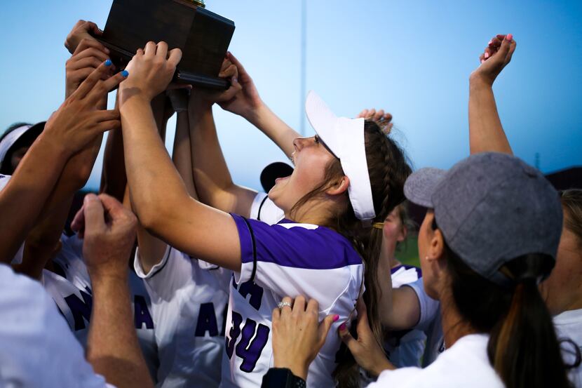 Anna's Hannah Morland hoists a trophy after their 11-2 victory in a Class 4A Region II...