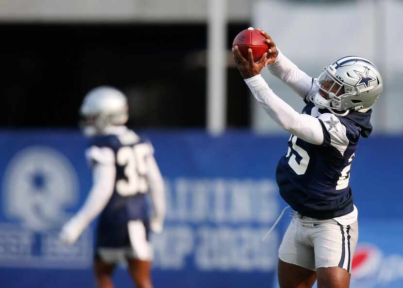 Dallas Cowboys safety Xavier Woods (25) catches the ball in a drill during training camp at...