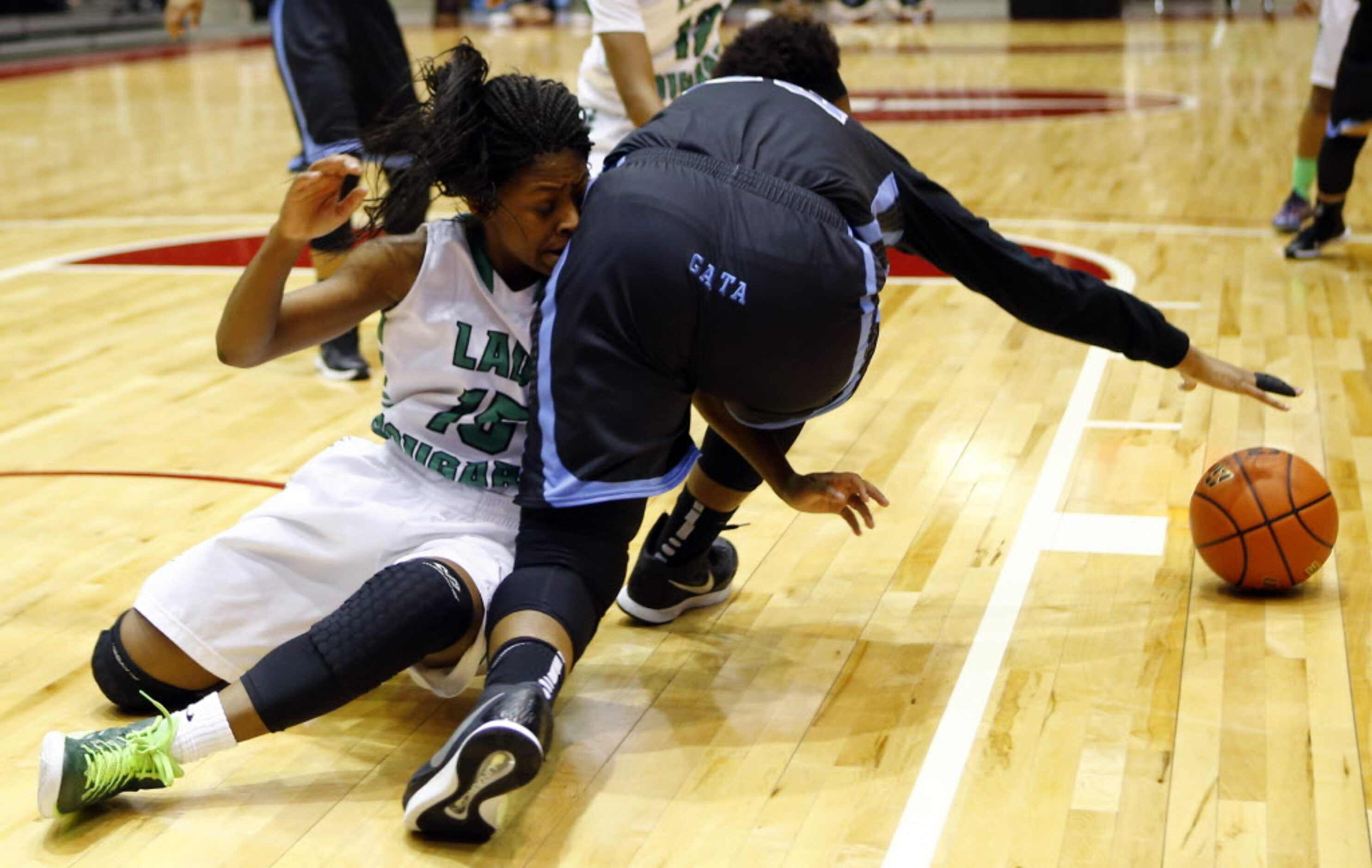 Bryan Adams' DeBrashia Baty (15) and Arlington Seguin's Tajshia Moore (33) battle for a...