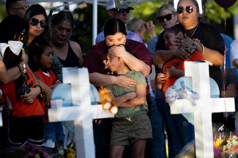 Geneva Uriegas (center) holds her daughter Gabriella on Thursday, May 26, 2022, as they...