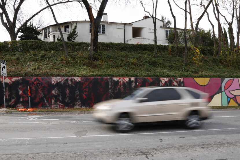 A motorist passes by the defaced Shepard Fairey murals along Sylvan Ave. in Dallas, Tuesday,...