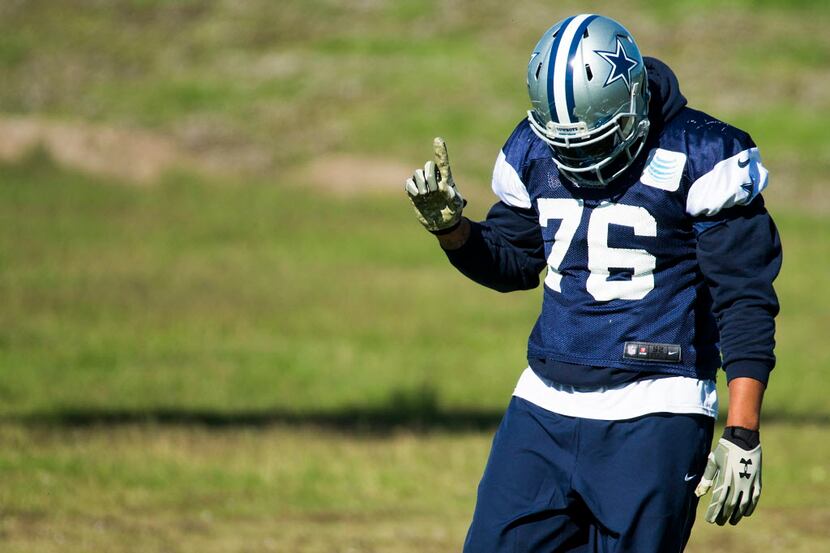 Dallas Cowboys defensive end Greg Hardy waves a finger as he dances to music while...