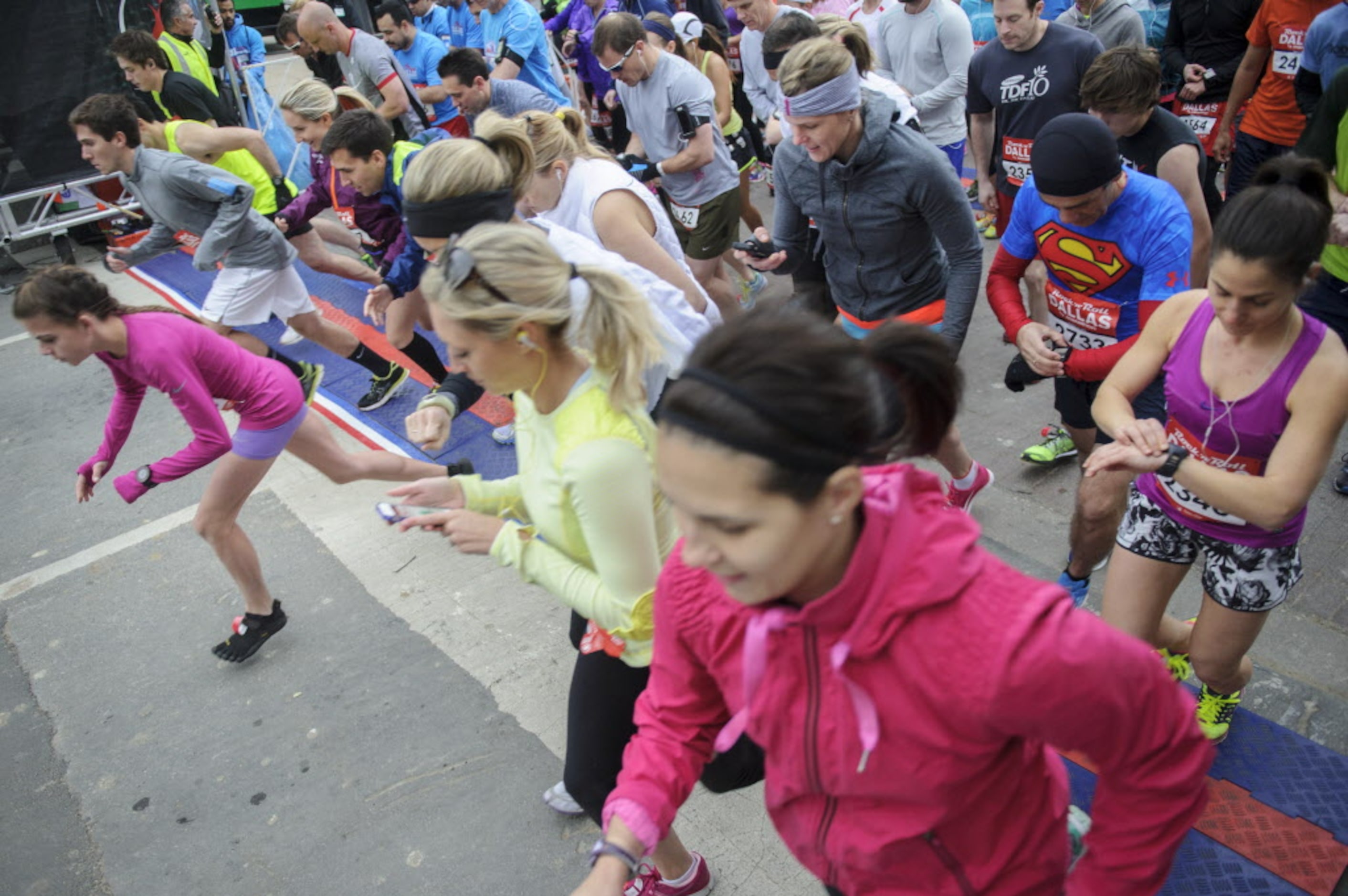 Runners take off as they start the Dallas Rock N' Roll half-marathon on Sunday, March 23, 2014.