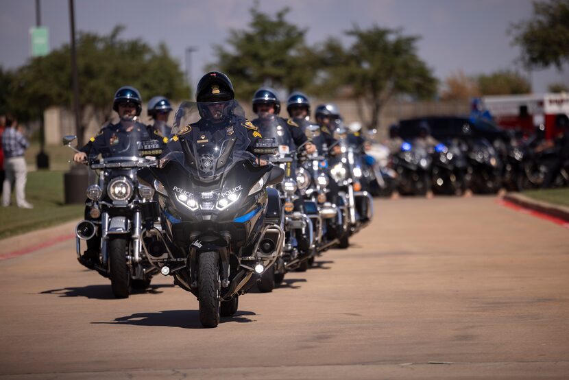 Motorcycle officers leads the procession following Arlington police Officer Darrin...