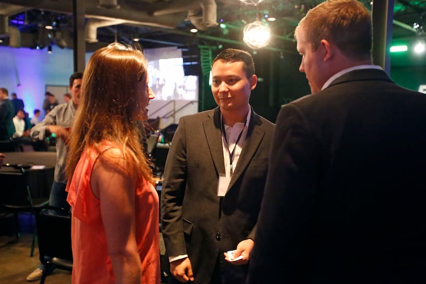 Entrepreneur Thomas Jung, center, talks with Tech Wildcatters CEO Gabriella Draney Zielke,...