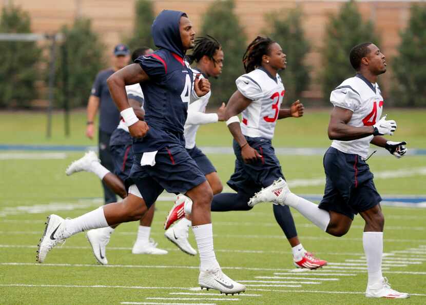 Houston Texans' Deshaun Watson (4) sprints across the field with teammates at the start of a...