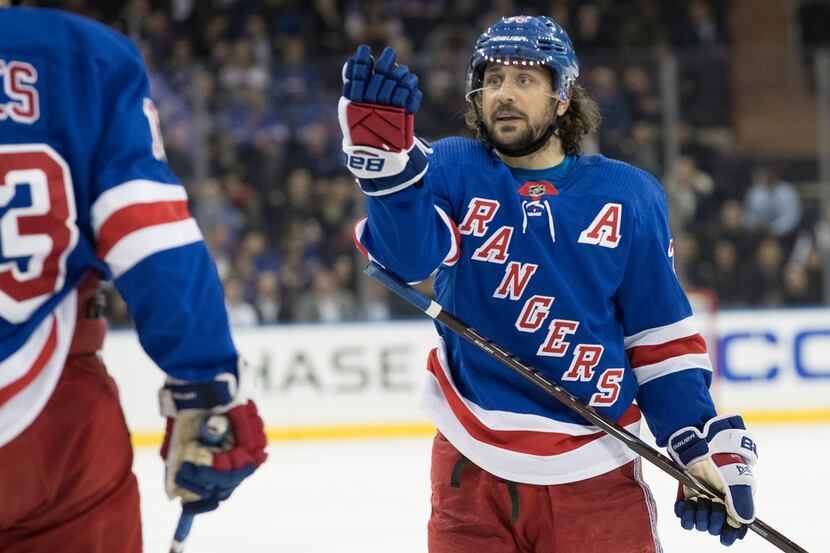 New York Rangers right wing Mats Zuccarello (36) talks tocenter Kevin Hayes (13) in the...
