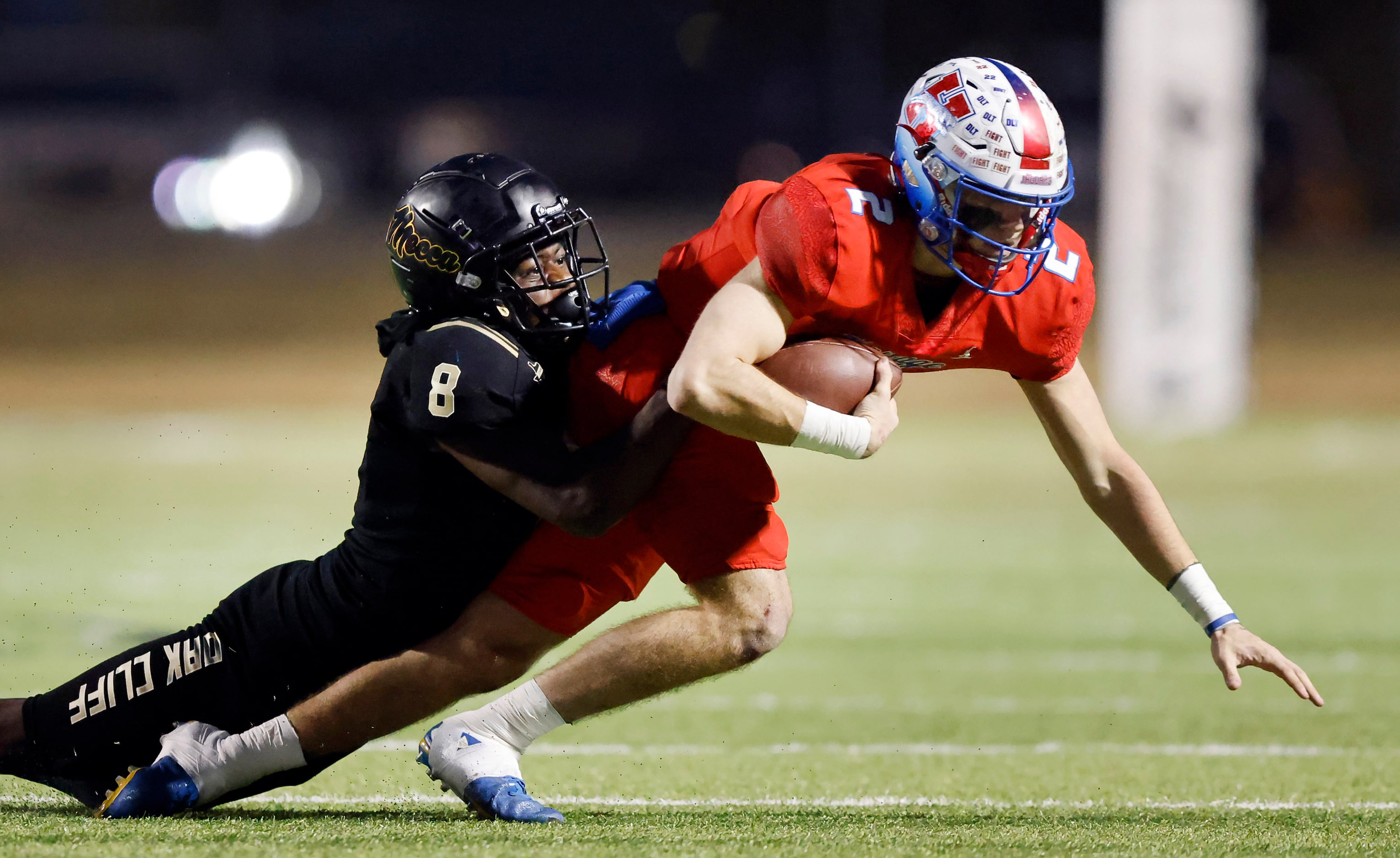 Midlothian Heritage quarterback Kaden Brown (2) is chased down and tackled by South Oak...