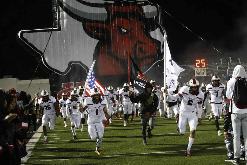 Cedar Hill takes the field in the second half of their game against DeSoto at Eagle Stadium...