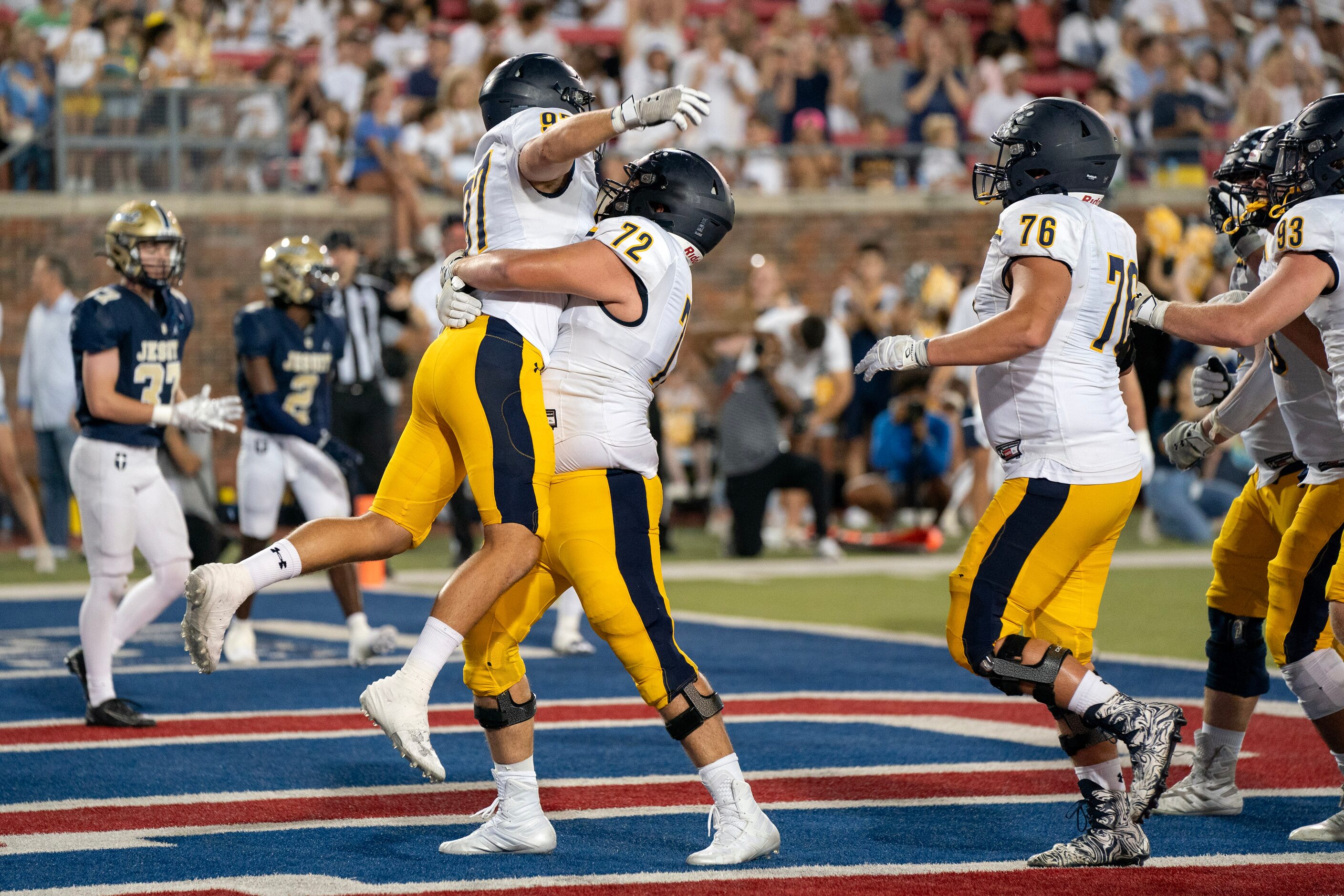 Highland Park junior offensive lineman Will Ogle (72) lifts senior lineman Henry Richter...