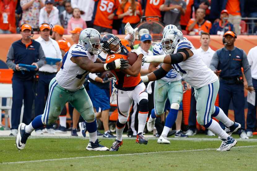 Denver Broncos cornerback Chris Harris (25) runs the ball against Dallas Cowboys offensive...