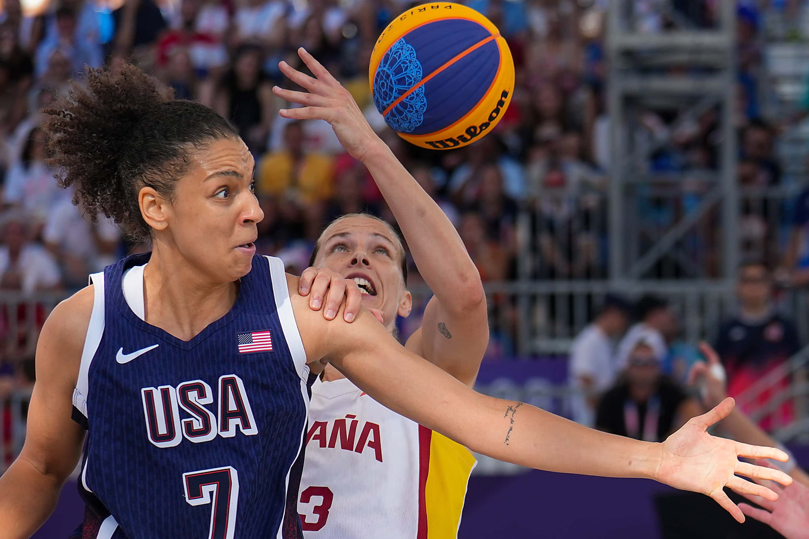 Cierra Burdick (7) of the United States fights for a rebound with Spain’s Sandra Ygueravide...