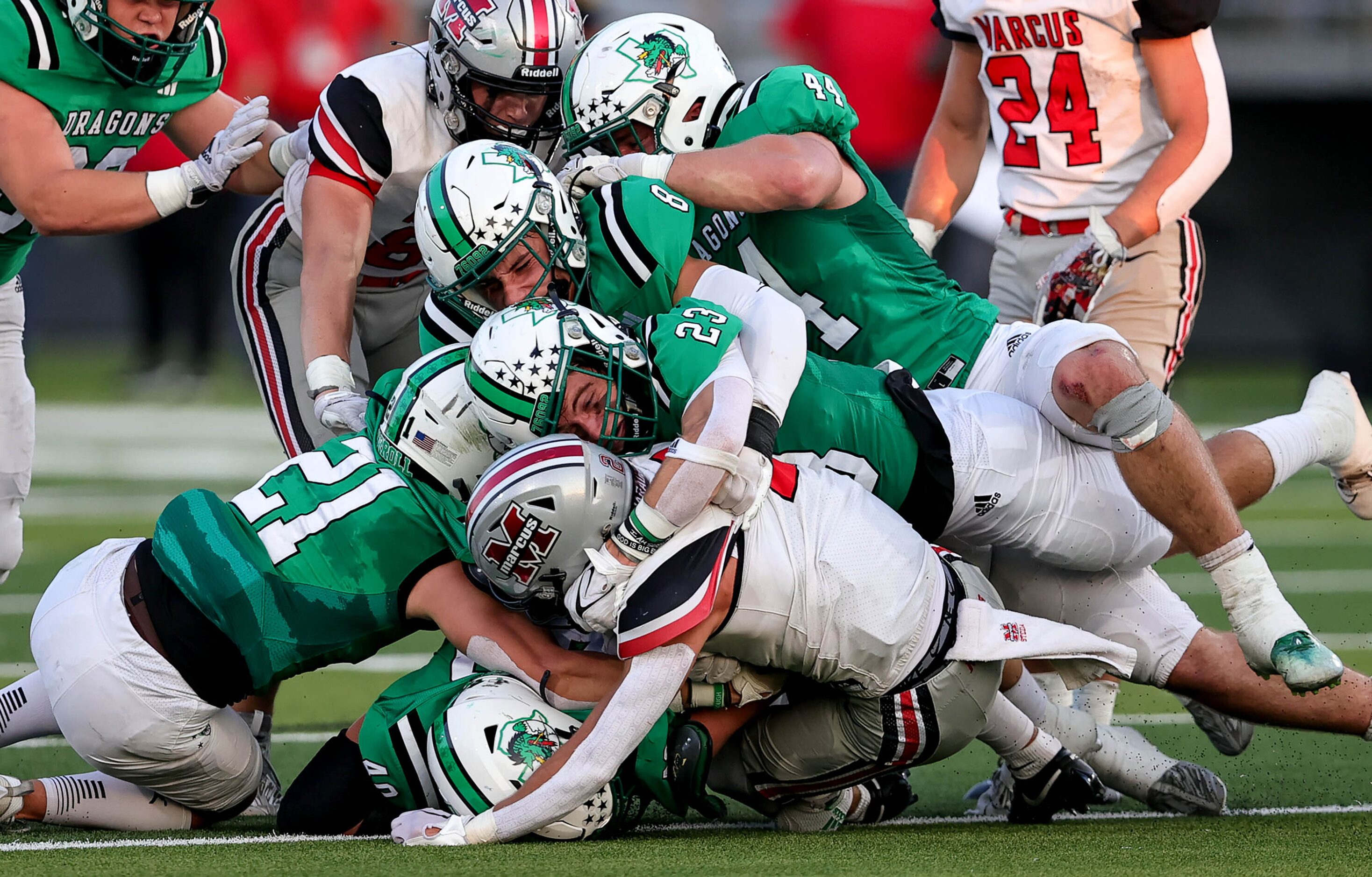 The Southlake Carroll defensive stuffs Flower Mound Marcus wide receiver Karic Grennan...