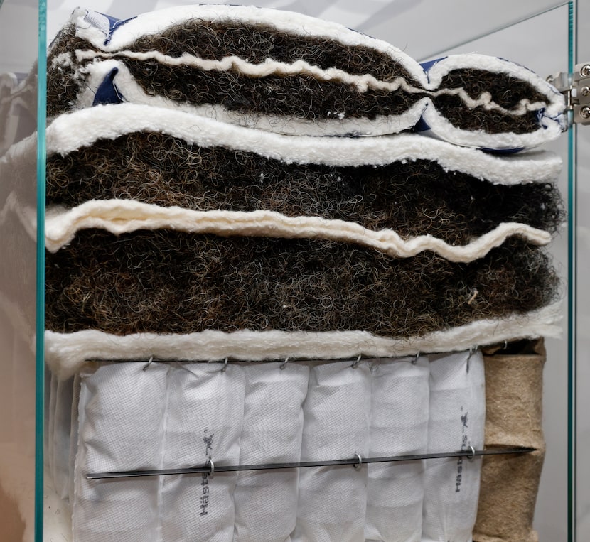 A cross section display shows the layers that make up a Hästens mattress, including its...