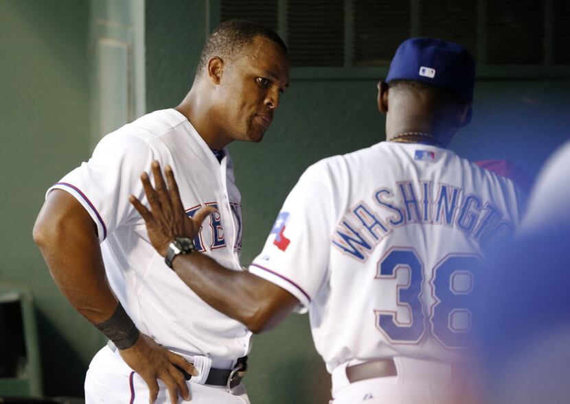 Texas Rangers manager Ron Washington (38) talks with Texas Rangers third baseman Adrian...