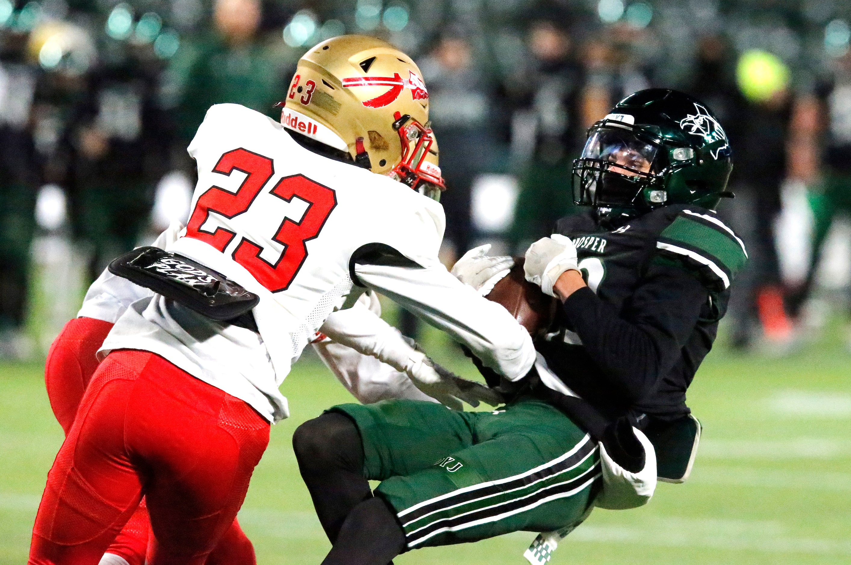 Prosper High School wide receiver Cole Marinelli (23) is hit by South Grand Prairie High...