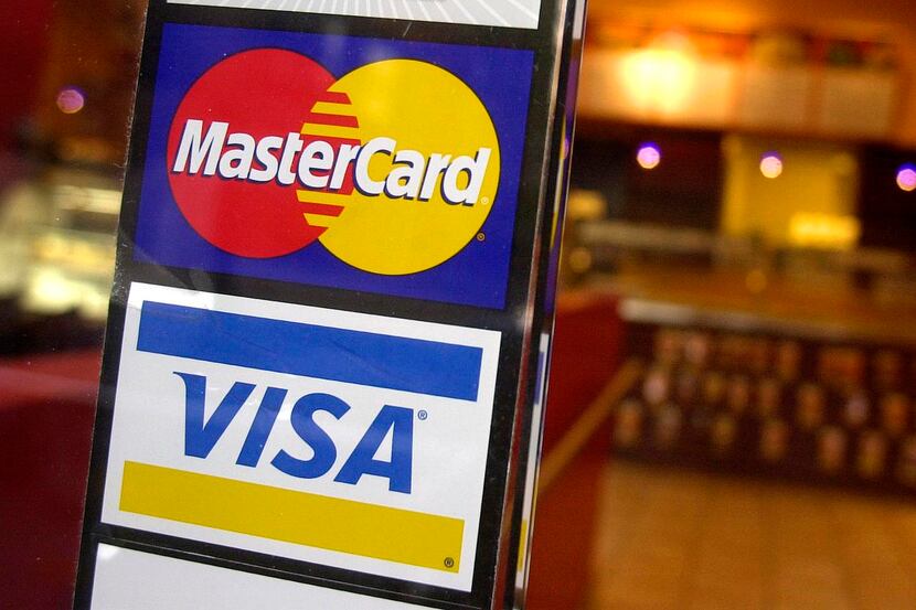 This April 22, 2005 file photo shows logos for MasterCard and Visa credit cards at the...