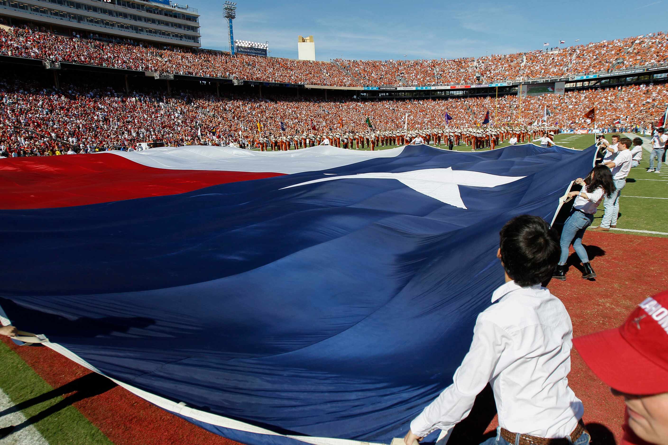 A large Texas flag is unfurled during pregame festivities before an NCAA college football...