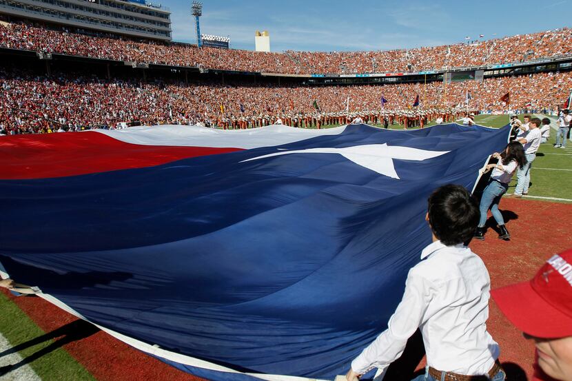 A large Texas flag is unfurled during pregame festivities before an NCAA college football...