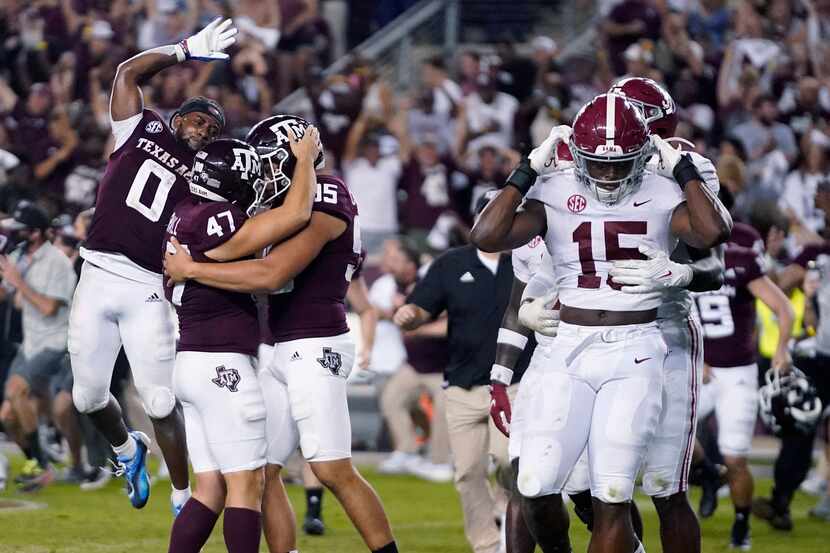 Texas A&M's Seth Small (47) celebrates with Nik Constantinou (95) and Ainias Smith (0) after...