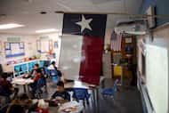 A Texas and American flag in a fifth grade classroom.