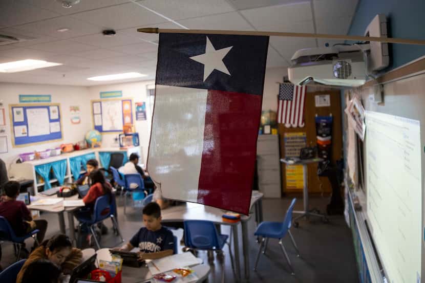 A Texas and American flag in a  fifth grade  classroom at the Bowie Fine Arts Academy in...