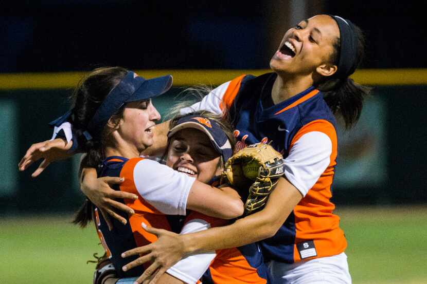 Wakeland's Sydney Cox (6, left) is hugged by team mates after she caught a fly ball in left...