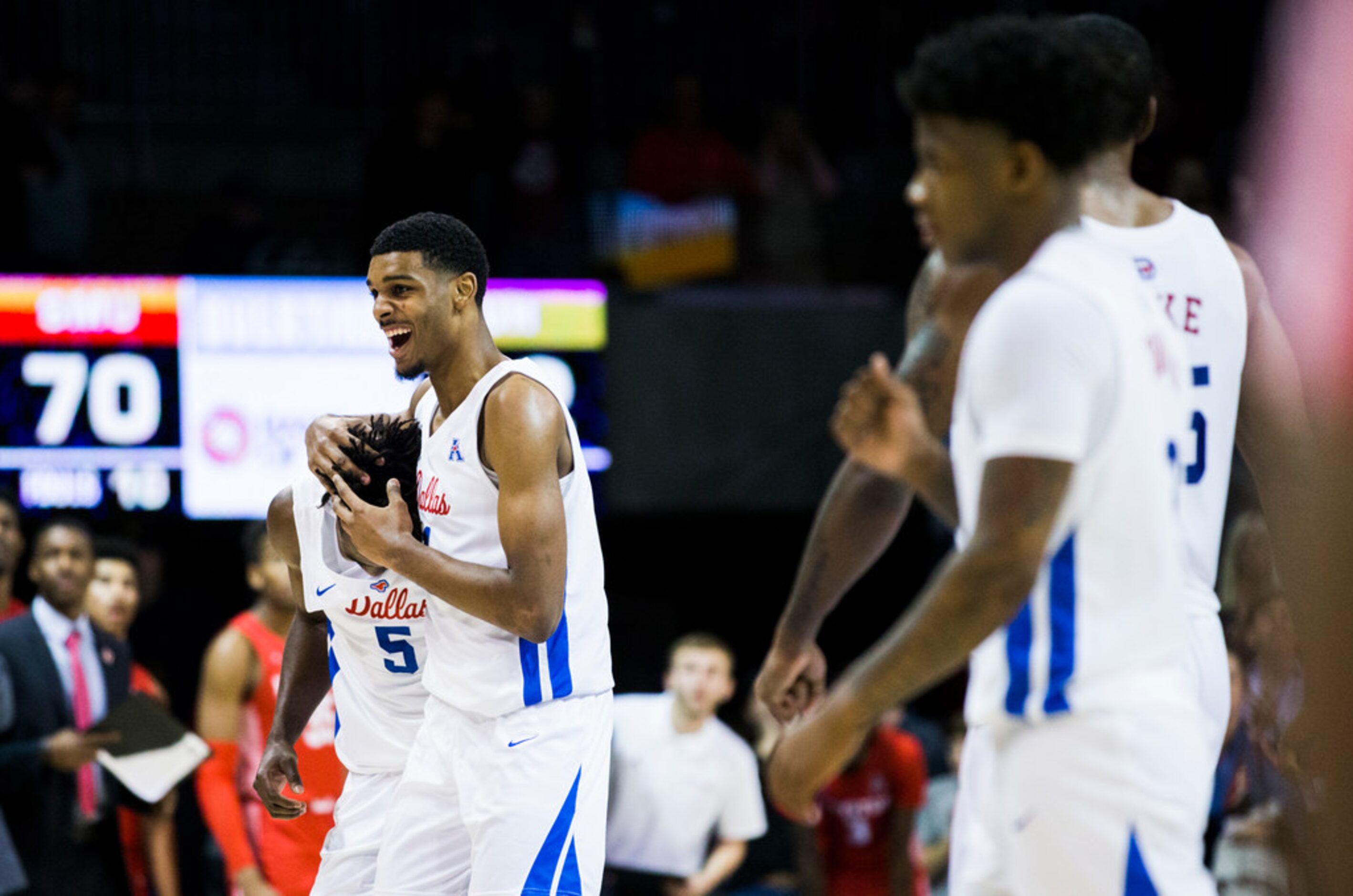 Southern Methodist Mustangs guard Emmanuel Bandoumel (5) gets a hug from forward Feron Hunt...