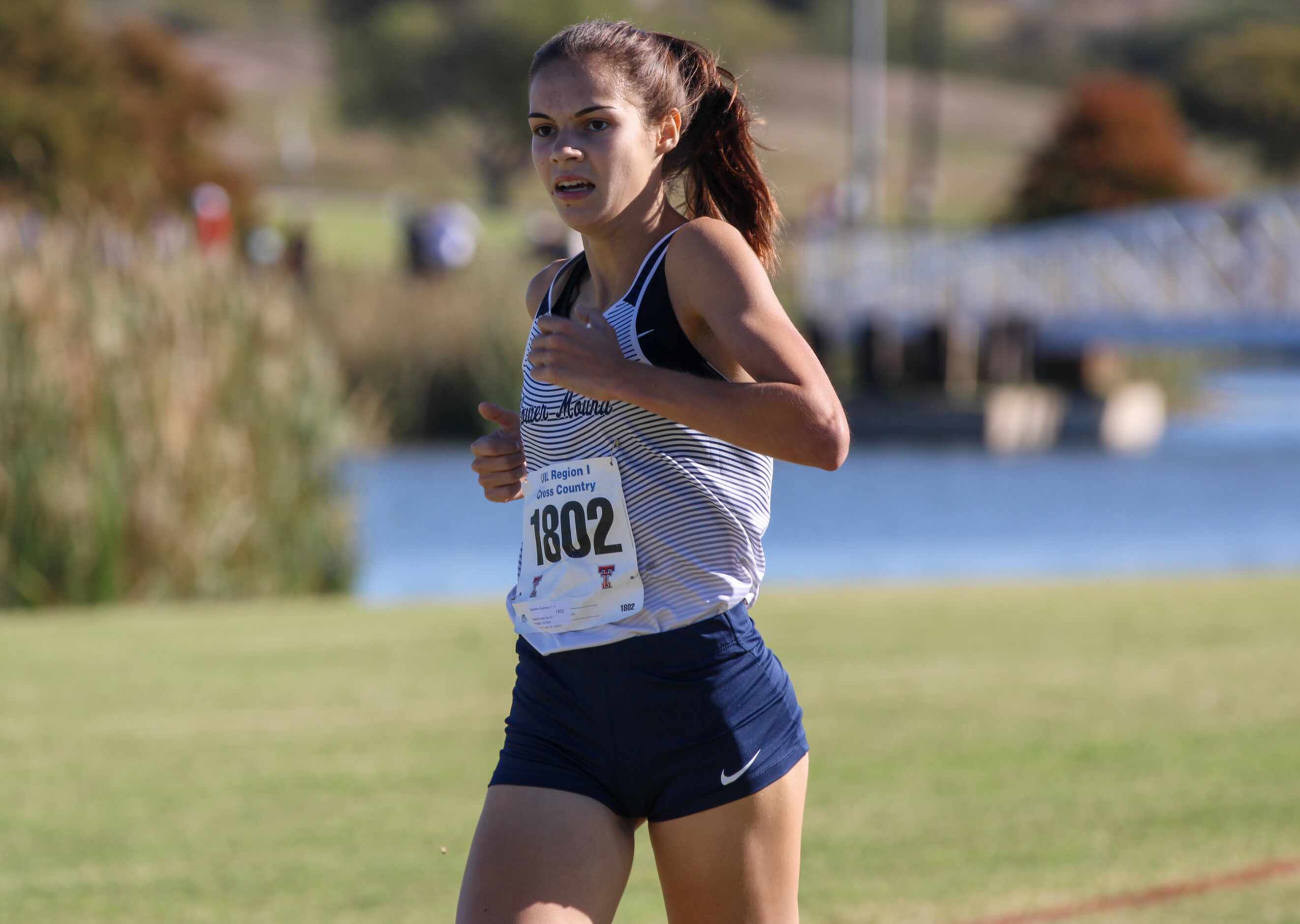 Flower Mound’s Samantha Humphries finishes off the victory in the Region I-6A girls cross...