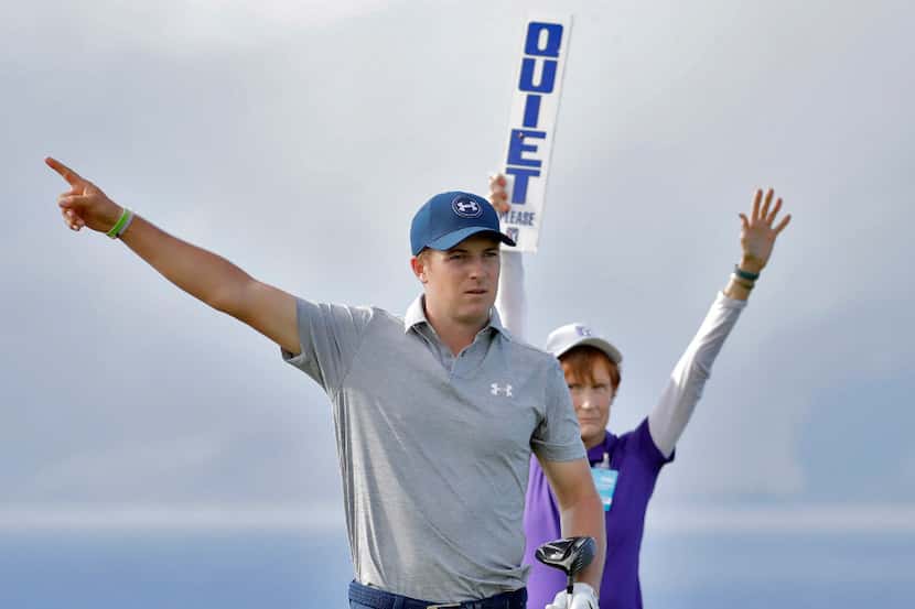Jordan Spieth signals his tee shot is wide right from the 13th tee during the first round of...