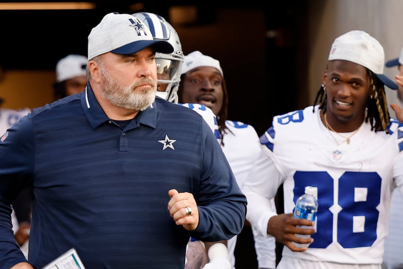 Dallas Cowboys head coach Mike McCarthy leads the Cowboys onto the field for their preseason...
