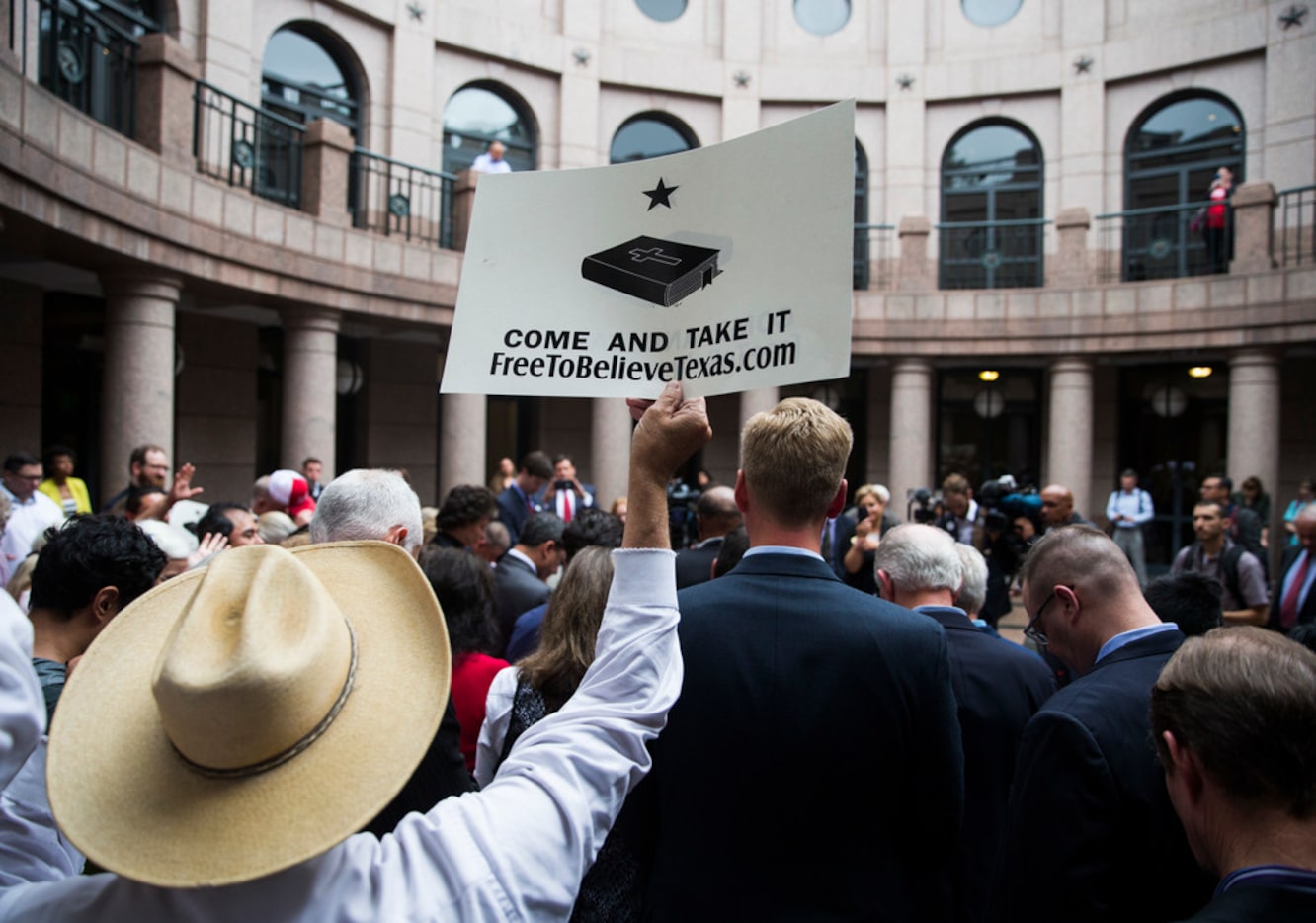 A supporter holds up a sign during a news conference as part of "Save Chick-Fil-A Day" at...