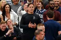 Dallas Mavericks minority owner Mark Cuban signals for a technical foul after LA Clippers...