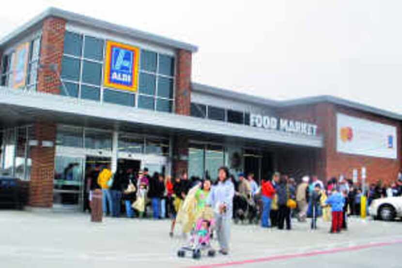  Shoppers check out the Aldi store at 5728 N. Tarrant Parkway in Fort Worth. The low-profile...