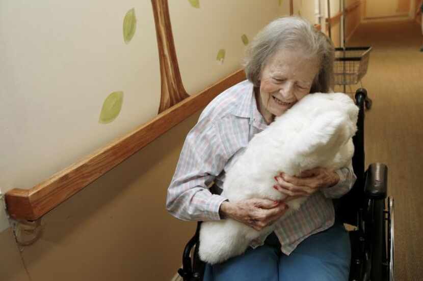 
Dorothy Hartley, 89, hugs a robotic pet named Paro at a retirement community in Cupertino,...